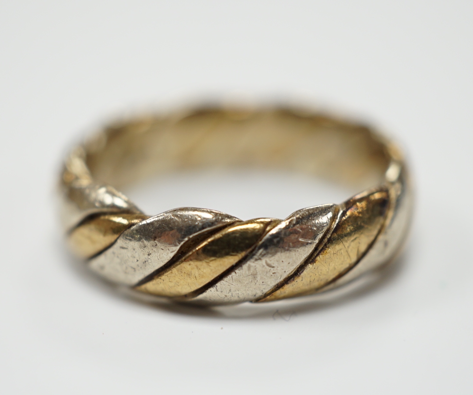 A two colour 9ct gold band size N, 6.3 grams.